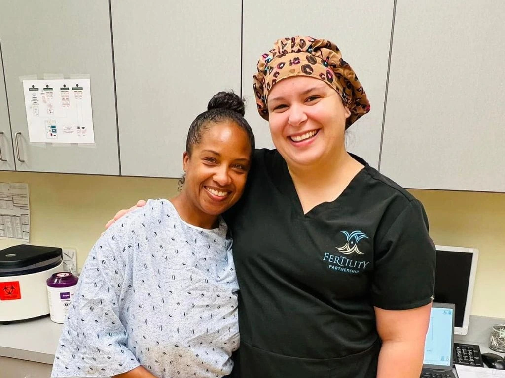 Patient and fertility clinic team member sharing a supportive moment at Fertility Partnership in St. Louis