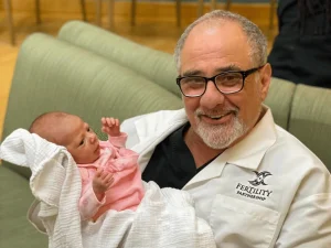 Dr. Elan Simckes with a baby at Fertility Partnership in Greater St. Louis